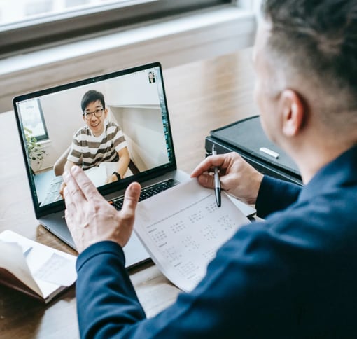 man in  video meeting using laptop